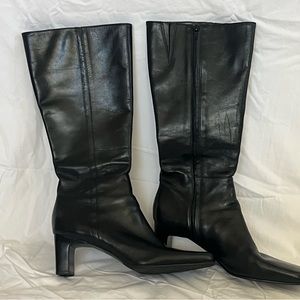 Just under knee high black boots, square toe.